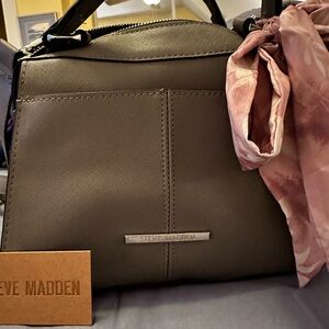Steve Madden gray, structured purse with handles and crossbody strap.
